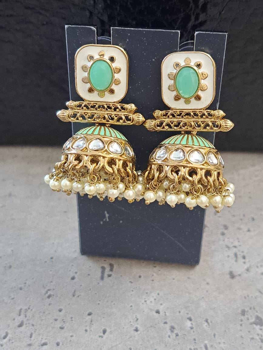 Kundan meenakari mint green jhumka with pearls .