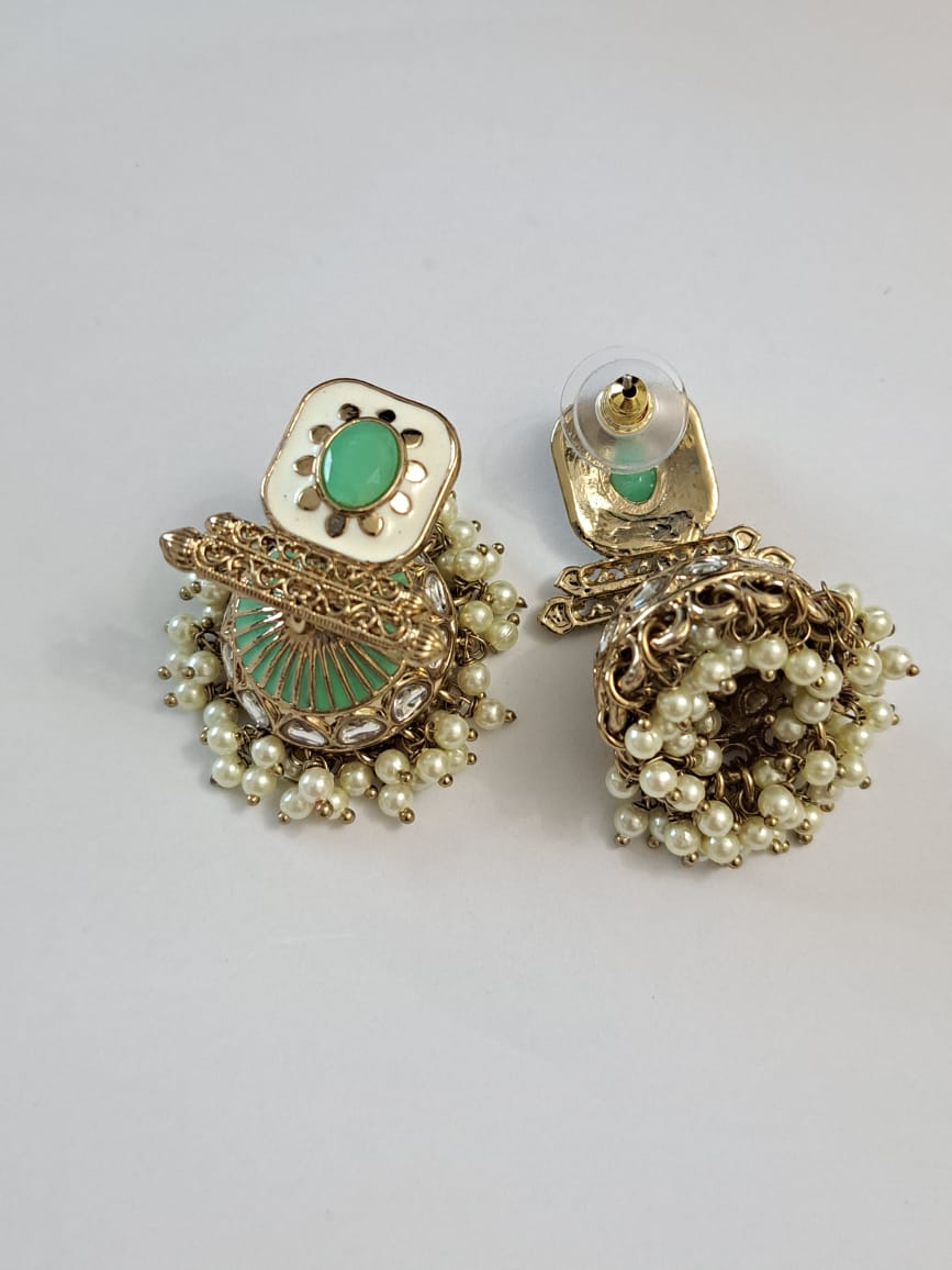 Kundan meenakari mint green jhumka with pearls .
